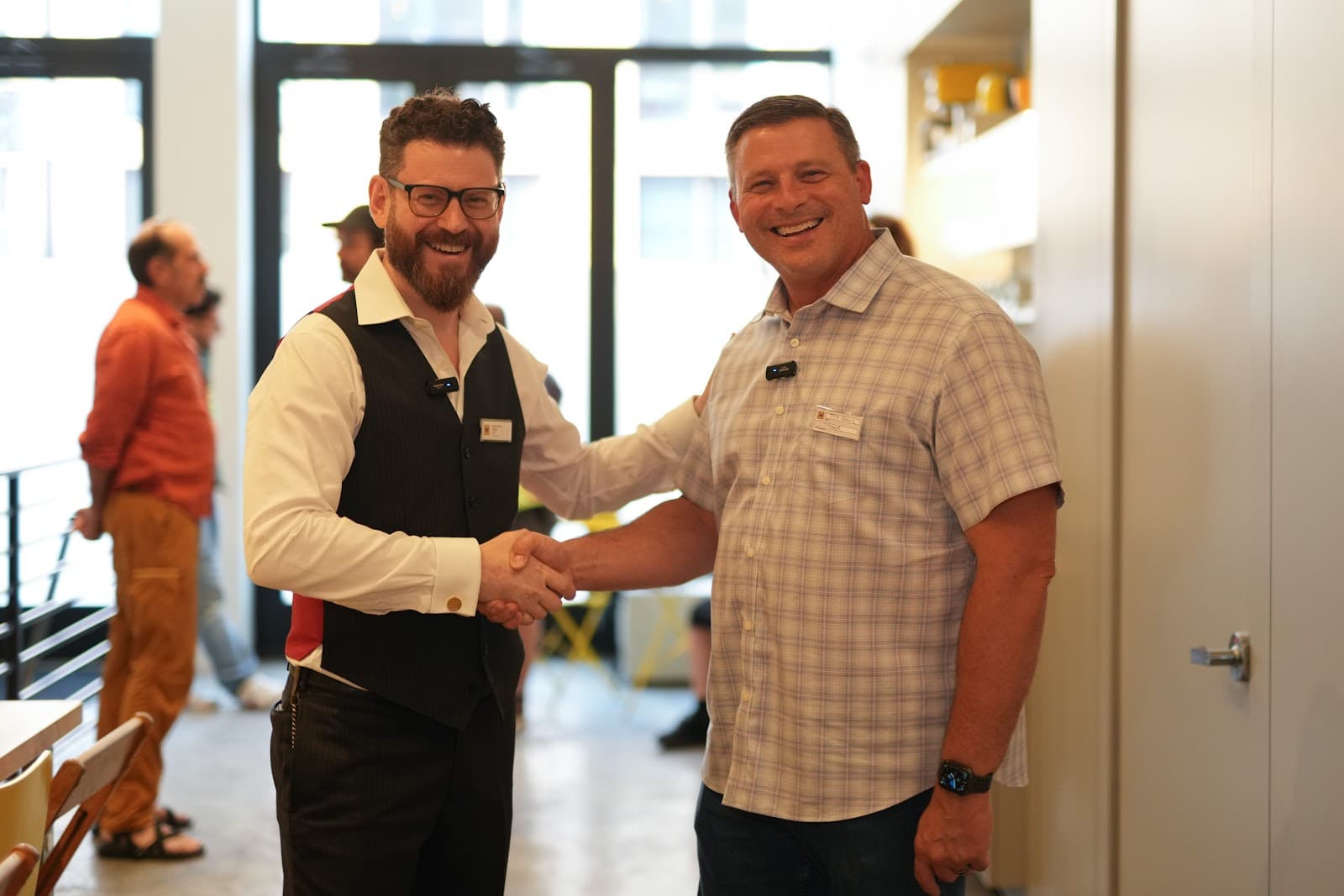 Noah Landow and Jim Franz shaking hands in the Macktez office before the Modern Alchemy Tête-à-Tech